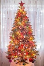 Beautiful Christmas tree with colorful decorations, and huge red star on top