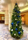 Christmas tree decorated in blue and gold ornaments in hotel lobby in Vancouver, BC Royalty Free Stock Photo