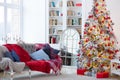 A beautiful Christmas tree in a decorated living room with a sofa. Festive interior Royalty Free Stock Photo