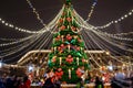 Beautiful Christmas tree at the fair, decorated with Christmas lights in the style of the Nutcracker and Mouse King fairy tale. St Royalty Free Stock Photo