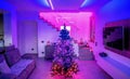 Beautiful Christmas Tree inside a modern house with led strips lighting. Holidays concept Royalty Free Stock Photo