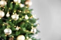 Beautiful Christmas tree with lights against grey background, blurred view