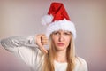 Beautiful Christmas woman with thumbs down sign