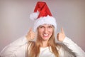 Beautiful Christmas woman with thumbs up sign