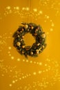 Beautiful Christmas wreath with bows, balls and cones hanging near wall, closeup Royalty Free Stock Photo