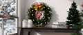 Beautiful Christmas wreath and Christmas tree on wood table with window with beautiful snow view