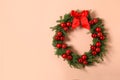 Beautiful Christmas wreath with festive decor on coral wall, space for text Royalty Free Stock Photo