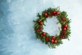 Beautiful Christmas wreath with festive decor on light blue wall, space for text Royalty Free Stock Photo