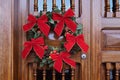 Beautiful Christmas wreath at the wooden door Royalty Free Stock Photo