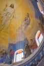 Beautiful church dome with stained glass windows. Church ceiling with religious painting. Painted cathedral ceiling.