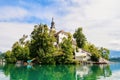 Church on an island in the middle of Lake Bled in Slovenia. Church tower illuminated by the sun with reflection in the lake. Royalty Free Stock Photo