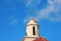 Church tower with golden cross against a blue sky and flying birds Royalty Free Stock Photo