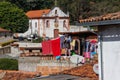 Beautiful city with colonial Portuguese architecture and churches in Brazil. Woman hangs clothes in a poor quarter