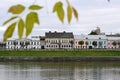 Beautiful city landscape with a view of the embankment with old Russian buildings in autumn. Architecture of a small town.