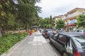 Beautiful city landscape view. Parked cars near outdoor restaurant on bright summer day. Greece