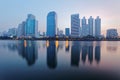 Beautiful city skyline of Bangkok at dawn with lakeside skyscrapers and reflections Royalty Free Stock Photo