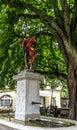 Beautiful City Street View of the colorful medieval Messenger statue on top of elaborate fountain in Bern, Switzerland.