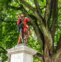 Beautiful City Street View of the colorful medieval Messenger statue on top of elaborate fountain in Bern, Switzerland.