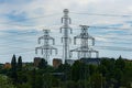 Beautiful cityscape at cloudy day with tree energy towers and a lot of energy lines with trees and bushes around Royalty Free Stock Photo