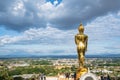 Beautiful cityscape and golden buddha statue on the mountain at Wat Phrathat Khao Noi at nan thailand