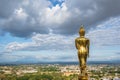 Beautiful cityscape and golden buddha statue on the mountain at Wat Phrathat Khao Noi at nan thailand