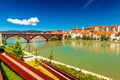 The beautiful cityscape of Maribor with the Old Bridge over the Drava River, the embankment and old buildings with orange tiled