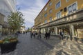 Beautiful cityscape view of Uppsala downtown street with walking people on bright day. Sweden. Europe.