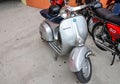 Beautiful classic gray Vespa motorcycle parked on a road on display