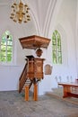 beautiful classic wooden pulpit in old church with gothic windows Royalty Free Stock Photo