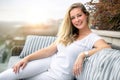 Beautiful classy woman living lifestyle portrait on luxurious rooftop terrace with a view during sunset Royalty Free Stock Photo