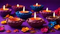 Beautiful clay Diya lamps with flowers on a dark purple background. Exquisite Diya\'s for Diwali decoration