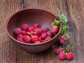 Pot of raspberries on a wooden table. raspberries in a plate. view from above Royalty Free Stock Photo