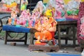 A Beautiful clay statue/Idol of an Indian god Lord Ganesha decorated with colorful drapery and Marigold garland