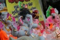 A Beautiful clay statue/Idol of an Indian god Lord Ganesha decorated with colorful drapery and Marigold garland