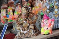 A Beautiful clay statue/Idol of an Indian god Lord Ganesha decorated with colorful drapery and Marigold garland