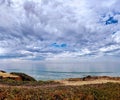 Beautiful clean ocean with calm waves under a blue sky with fluffy clouds during the daytime Royalty Free Stock Photo