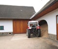 Beautiful clean tractor stands near a sawdust with a wood sawdust Royalty Free Stock Photo