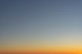 Beautiful clear, morning sky at sunrise, natural background. Soft gradient from orange to blue