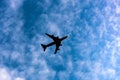 Plane silhouette in blue sky