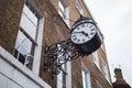 Black vintage clock on Doughty Street Royal Oak, London, UK Royalty Free Stock Photo