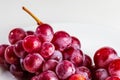 Beautiful close-up of cluster of red grapes inks on table.