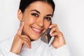 Beautiful close up portrait of attractive young happy woman with mobile phone with pretty toothy smile, on the white background. Royalty Free Stock Photo