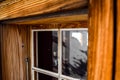 Beautiful close-up view of an old, weathered wooden window with a big window frame seen at a mountain cabin in the Swiss Alps, Swi Royalty Free Stock Photo