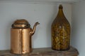 Beautiful close up view of retro vintage interior decoration details. Old cooper teapot and glass bottle filled with bottle corks Royalty Free Stock Photo