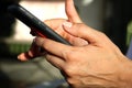 Close up of women`s hands holding smartphone. Her watching sms, message, e-mail on mobile phone in coffee shop. Blurred background Royalty Free Stock Photo