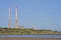 Beautiful closeup bright view of iconic Poolbeg power station chimneys and Poolbeg CCGT station against clear blue sky