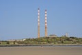 Beautiful closeup bright view of iconic Poolbeg power station chimneys and Poolbeg CCGT station against clear blue sky Royalty Free Stock Photo