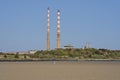 Beautiful closeup bright view of iconic Poolbeg power station chimneys and Poolbeg CCGT station against clear blue sky Royalty Free Stock Photo