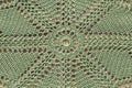 Beautiful closeup crochet doily on old wooden background