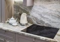 beautiful closeup of custom designed kitchen, with marble looking quartz countertop and backsplash. cream electric kettle with Royalty Free Stock Photo